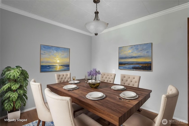 dining space with crown molding, baseboards, and wood finished floors