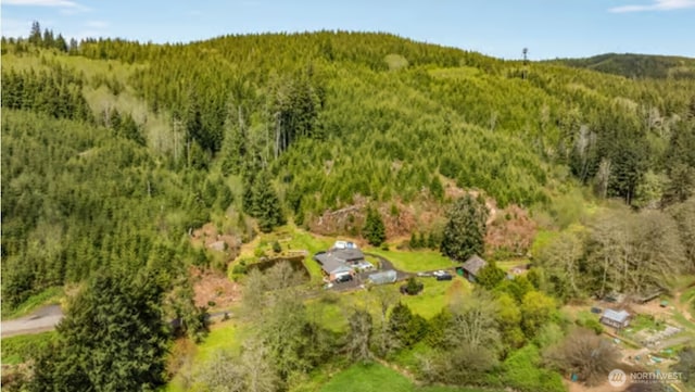 drone / aerial view featuring a wooded view