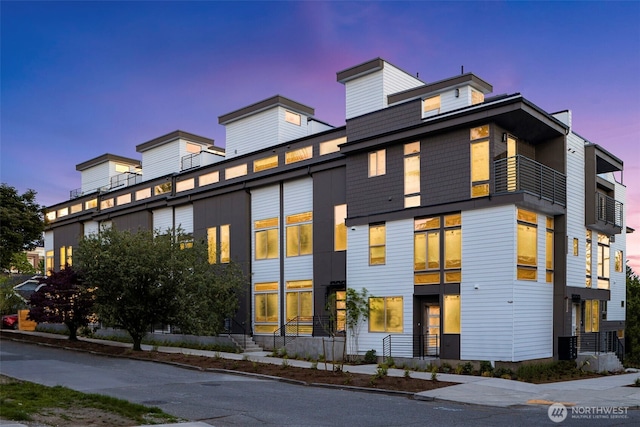 view of front of house featuring a balcony