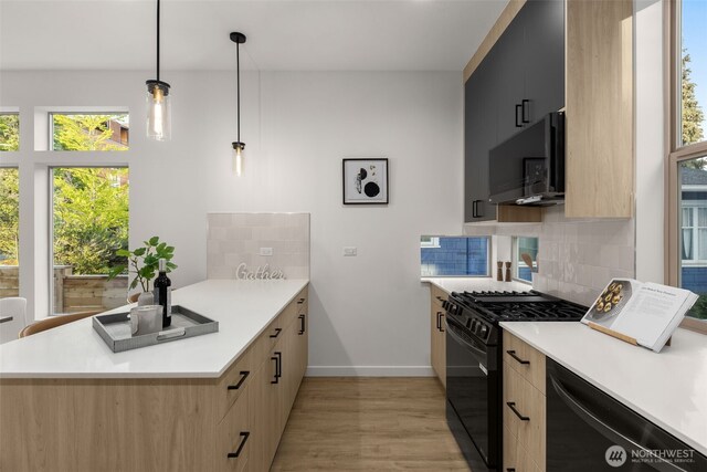 kitchen with black appliances, light brown cabinetry, and light countertops