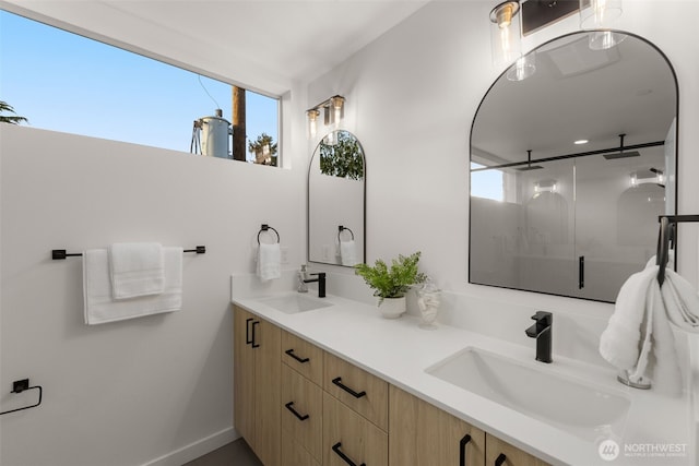 full bathroom with a shower stall, healthy amount of natural light, and double vanity