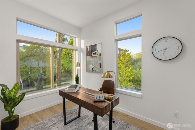 home office with wood finished floors and baseboards