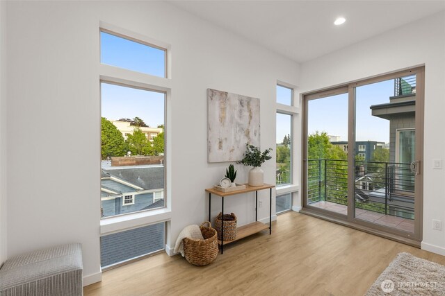 entryway with wood finished floors, recessed lighting, and baseboards