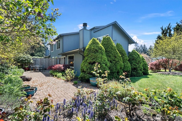1123 N Whitman, Tacoma, WA 98406 - view of property exterior featuring a lawn, fence, and a patio area