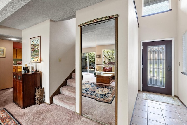 1123 N Whitman, Tacoma, WA 98406 - entrance foyer featuring baseboards, stairs, light carpet, and a textured ceiling