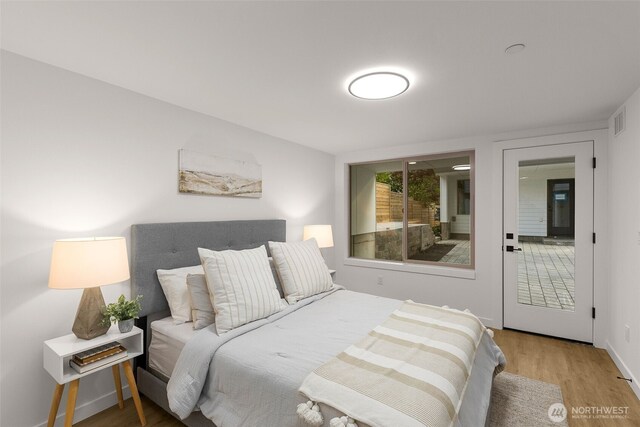 bedroom with wood finished floors and baseboards