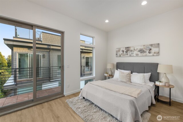 bedroom featuring wood finished floors, access to outside, recessed lighting, and baseboards