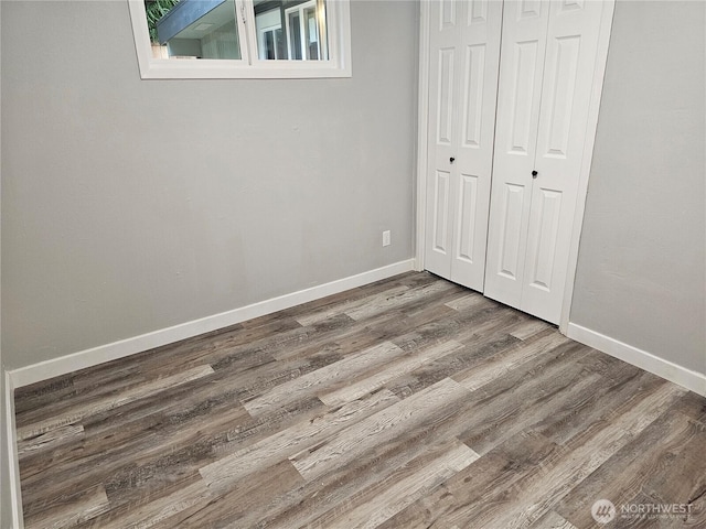 16738 2nd Ave NE, Shoreline, WA 98155 - unfurnished bedroom with wood finished floors, a closet, and baseboards
