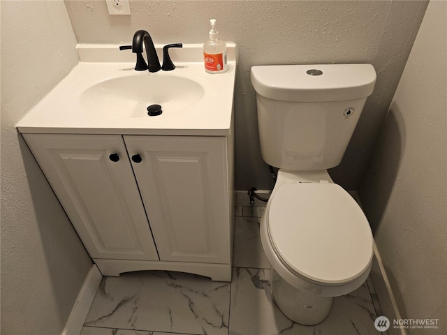 16738 2nd Ave NE, Shoreline, WA 98155 - half bath featuring marble look tiles, toilet, vanity, and baseboards