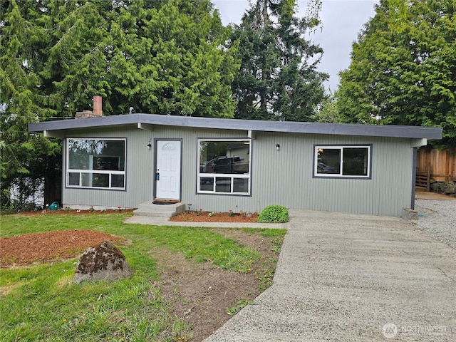 16738 2nd Ave NE, Shoreline, WA 98155 - view of front of property featuring fence, concrete driveway, and a chimney