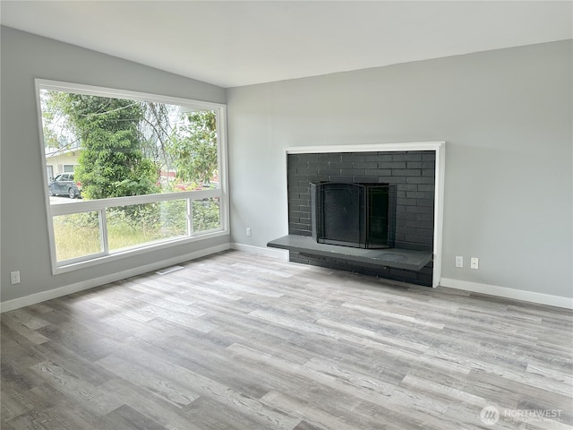16738 2nd Ave NE, Shoreline, WA 98155 - unfurnished living room featuring wood finished floors and a brick fireplace