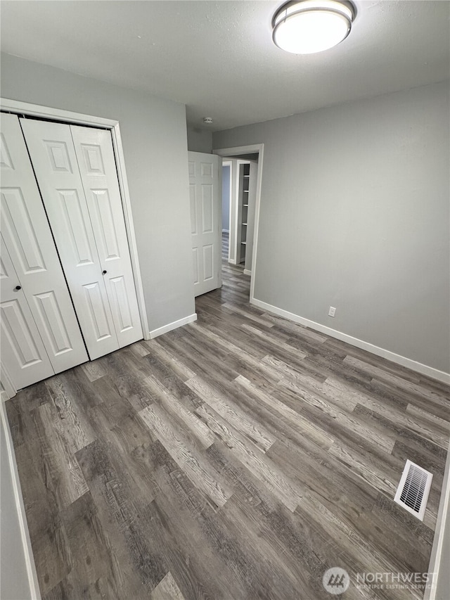 16738 2nd Ave NE, Shoreline, WA 98155 - unfurnished bedroom with wood finished floors and a closet