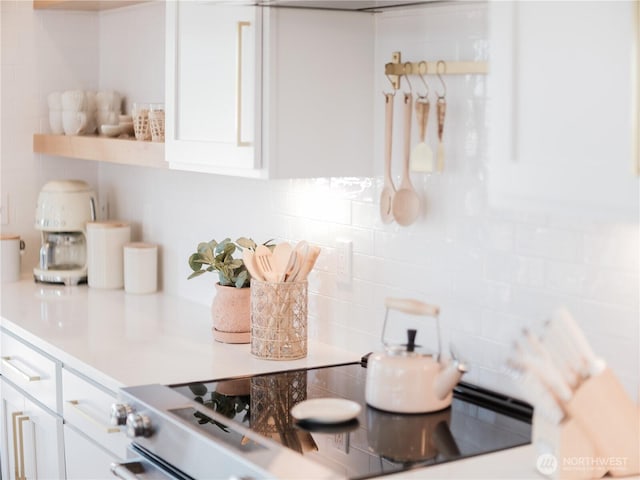 204 Market St Unit A, Pacific Beach, WA 98571 - interior space featuring backsplash, white cabinetry, and light countertops