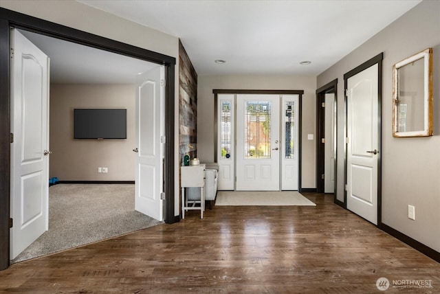 entryway with baseboards and wood finished floors