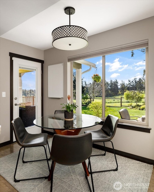 dining area with wood finished floors and baseboards