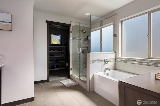 full bath with a bath, a shower stall, and tasteful backsplash