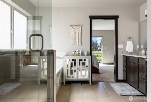 full bathroom featuring a bath, tile patterned flooring, and vanity