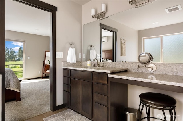 ensuite bathroom featuring ensuite bath, vanity, and visible vents