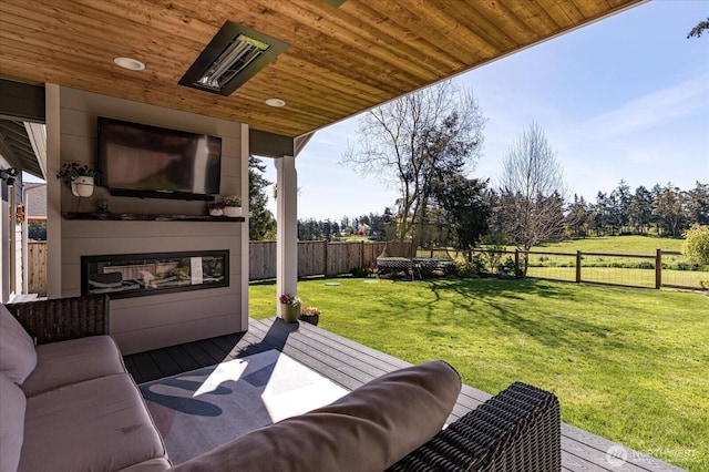 view of patio with a wooden deck and a fenced backyard