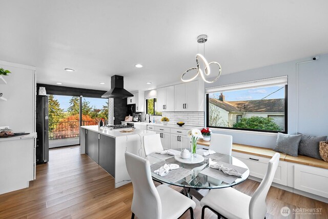 dining space with recessed lighting and light wood finished floors