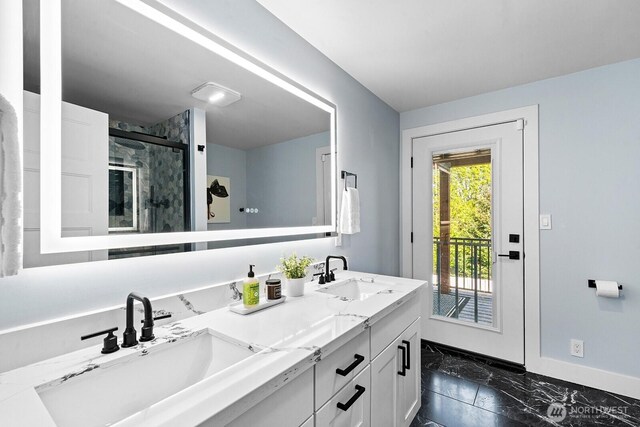 full bathroom featuring a shower stall, marble finish floor, baseboards, and a sink