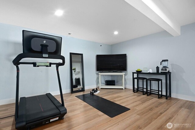 workout room with baseboards, wood finished floors, and recessed lighting