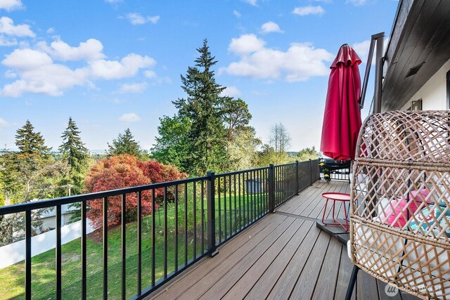 wooden terrace with a lawn