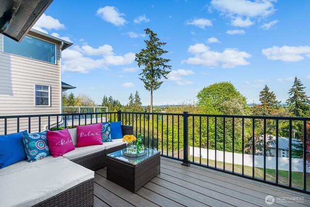 wooden terrace featuring an outdoor hangout area