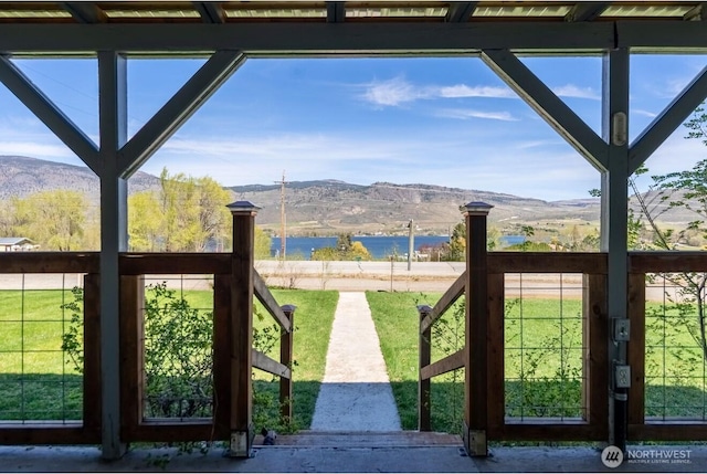 exterior space with a healthy amount of sunlight and a water and mountain view