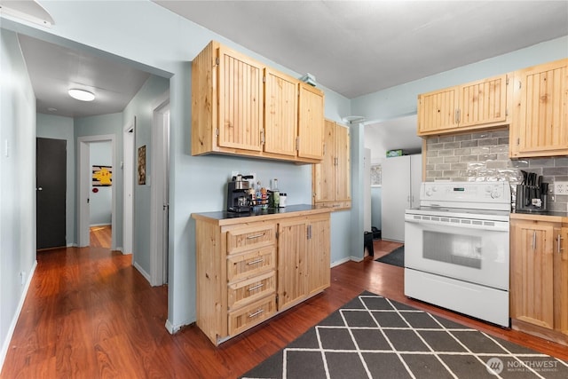 kitchen featuring dark wood-type flooring, tasteful backsplash, electric range, and light brown cabinetry