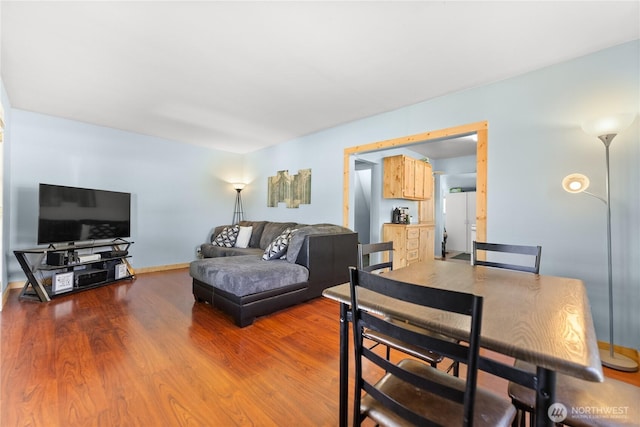 dining area featuring baseboards and wood finished floors