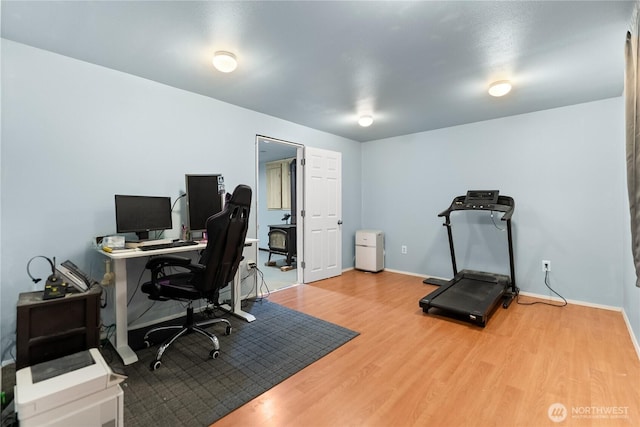 office space with wood finished floors and baseboards