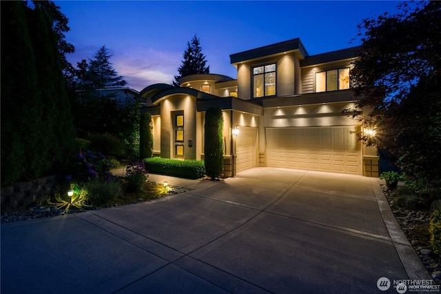 8131 116th Ave NE, Kirkland, WA 98033 - view of front of property with concrete driveway, an attached garage, and stucco siding