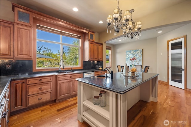 8131 116th Ave NE, Kirkland, WA 98033 - kitchen featuring a sink, decorative backsplash, light wood-style flooring, and a chandelier