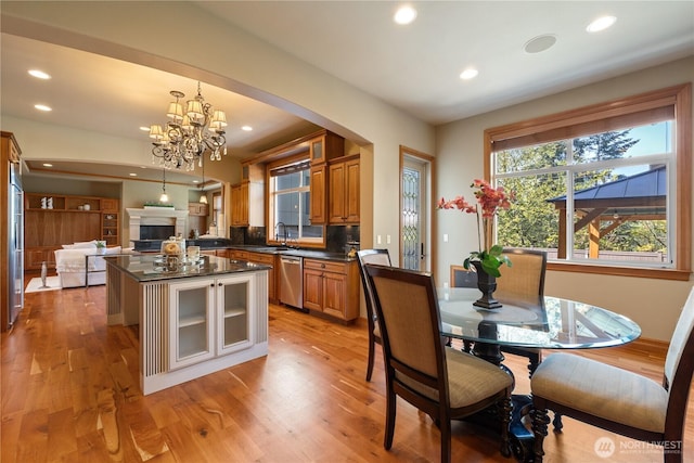 8131 116th Ave NE, Kirkland, WA 98033 - dining space featuring arched walkways, a notable chandelier, recessed lighting, and light wood-style floors
