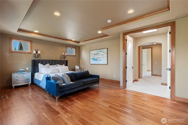 8131 116th Ave NE, Kirkland, WA 98033 - bedroom with light wood-style floors, a raised ceiling, recessed lighting, and arched walkways