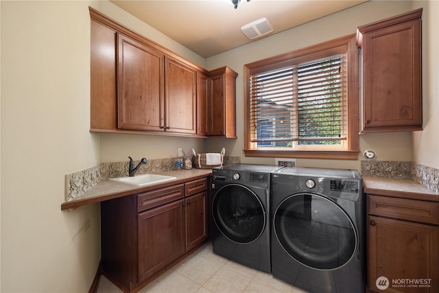 8131 116th Ave NE, Kirkland, WA 98033 - washroom featuring visible vents, light tile patterned flooring, separate washer and dryer, a sink, and cabinet space