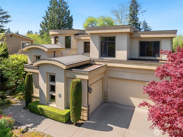 8131 116th Ave NE, Kirkland, WA 98033 - prairie-style house with a garage, stucco siding, metal roof, and a standing seam roof