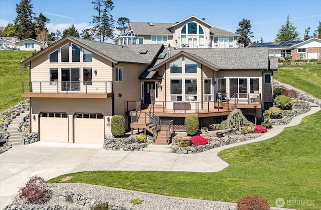 rear view of house with a lawn, stairs, and a garage