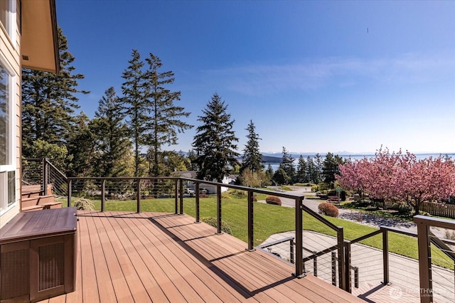 wooden deck featuring a lawn