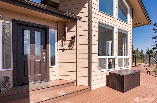property entrance with a deck