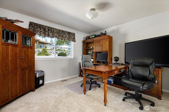 office space featuring light colored carpet, baseboards, and visible vents