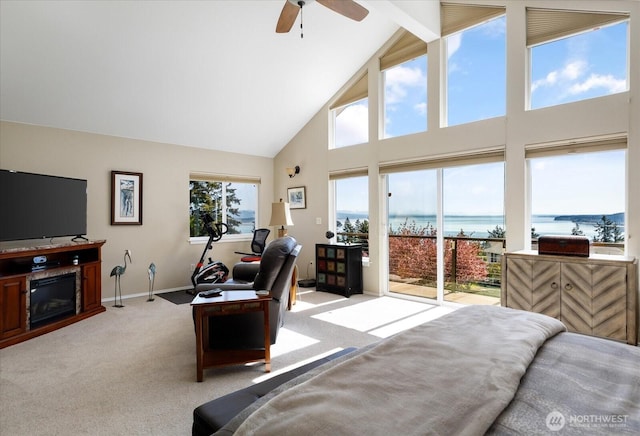 living area with high vaulted ceiling, a water view, ceiling fan, light carpet, and beam ceiling