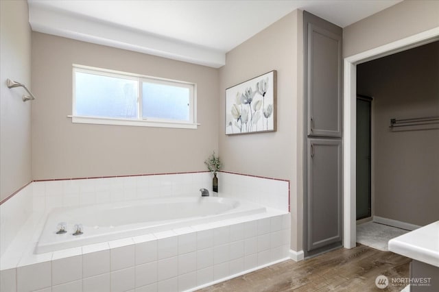 bathroom featuring a bath and wood finished floors