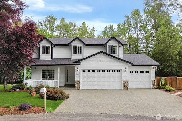 8203 32nd Ave E, Tacoma, WA 98443 - traditional-style house featuring an attached garage, stone siding, a porch, driveway, and a shingled roof