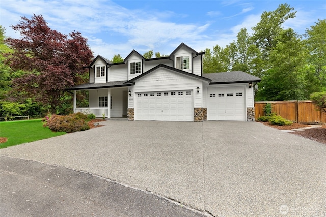 8203 32nd Ave E, Tacoma, WA 98443 - view of front of house with covered porch, a garage, stone siding, concrete driveway, and a shingled roof