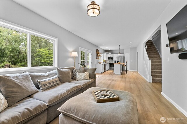 8203 32nd Ave E, Tacoma, WA 98443 - living room with stairs, light wood finished floors, baseboards, and recessed lighting