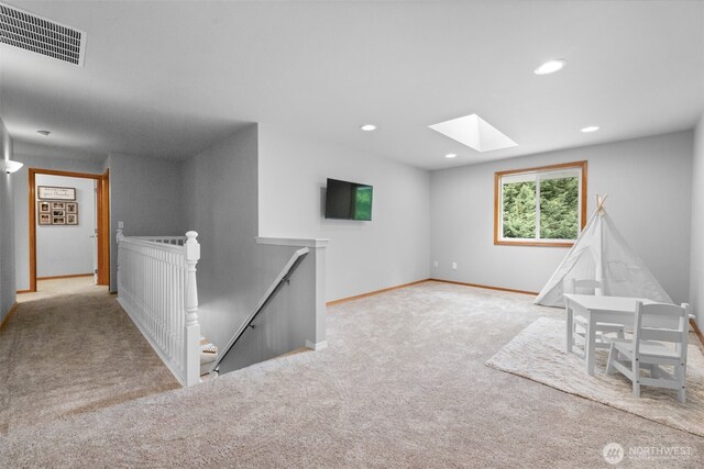 8203 32nd Ave E, Tacoma, WA 98443 - recreation room with a skylight, carpet, baseboards, and recessed lighting