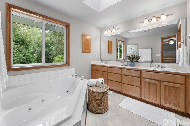8203 32nd Ave E, Tacoma, WA 98443 - bathroom with a skylight, double vanity, a tub with jets, and tile patterned floors