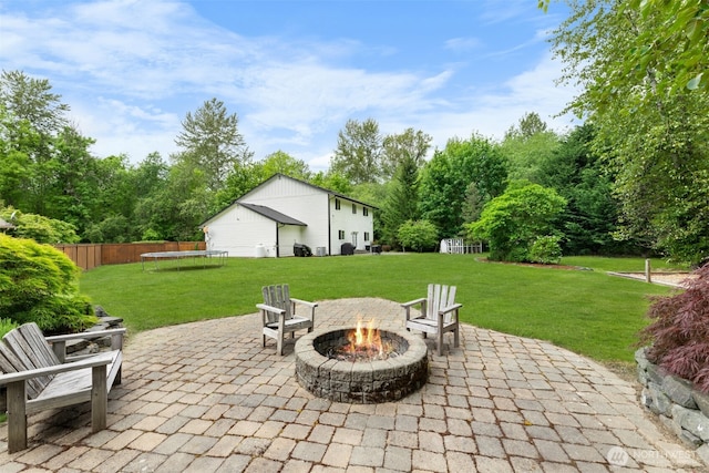 8203 32nd Ave E, Tacoma, WA 98443 - view of patio / terrace featuring a trampoline and a fire pit